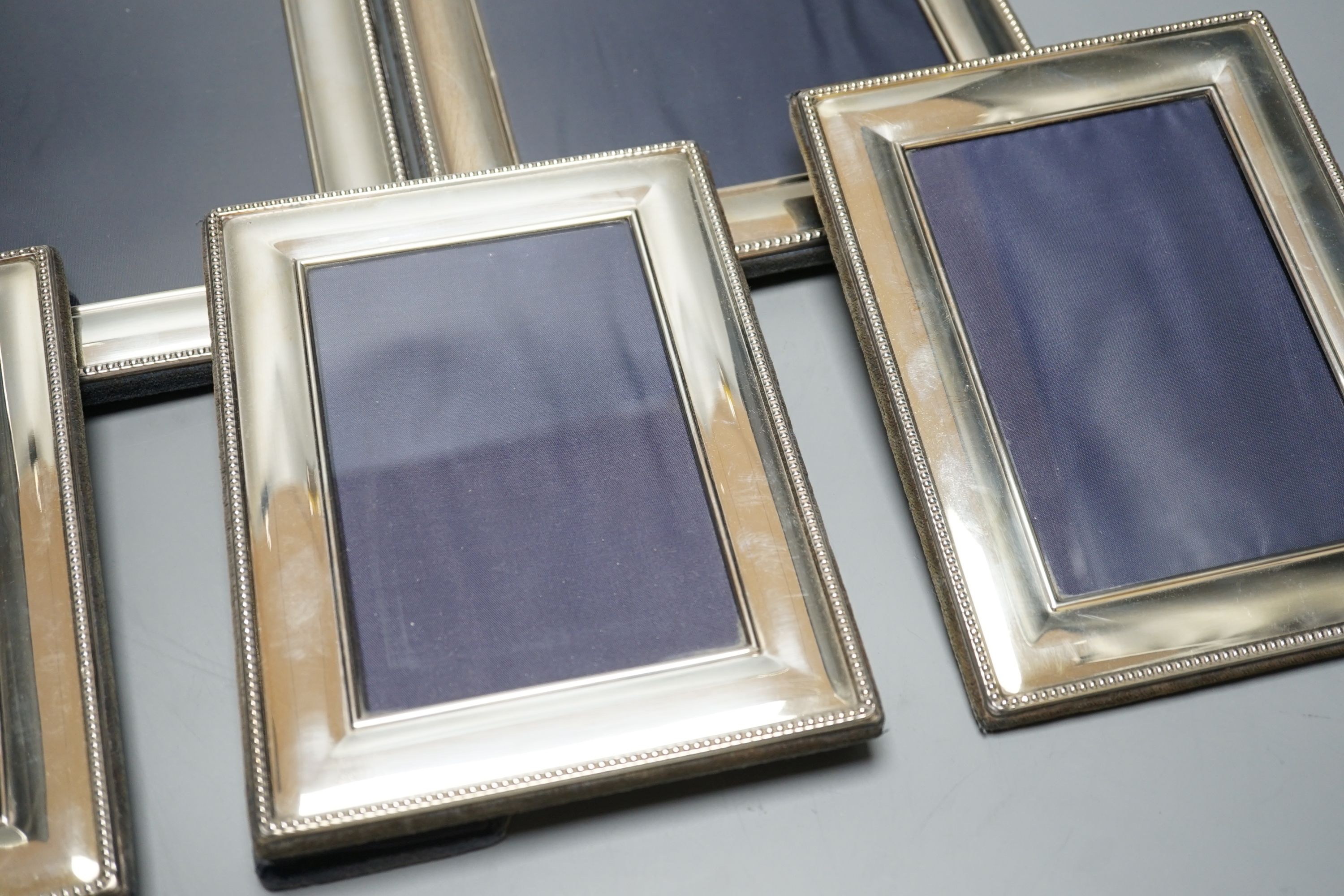 A modern pair of silver mounted photograph frames, Carrs of Sheffield, 2001, 26cm, and a set of three smaller frames, same maker, 2000, 20.2cm